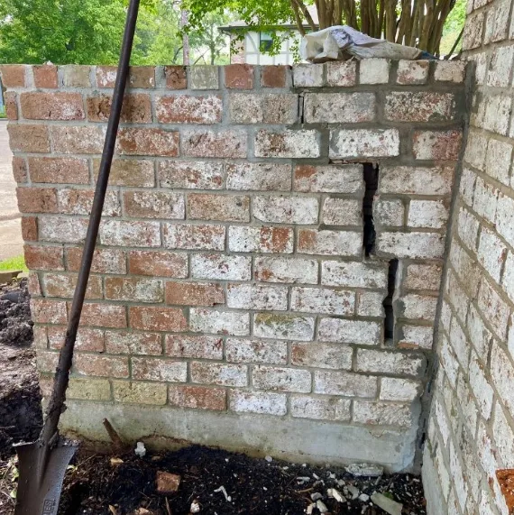 An example of a significantly cracked boundary fence (or garden fence) to the front boundary of a house.