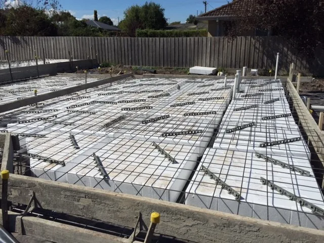 Example of a waffle slab or waffle raft prior to concrete placement. Here you can see the polystyrene blocks which help to form the concrete rubs which give the waffle slab its form. Mesh reinforcement is laid on top as part of the slab poured over the polystyrene blocks.
