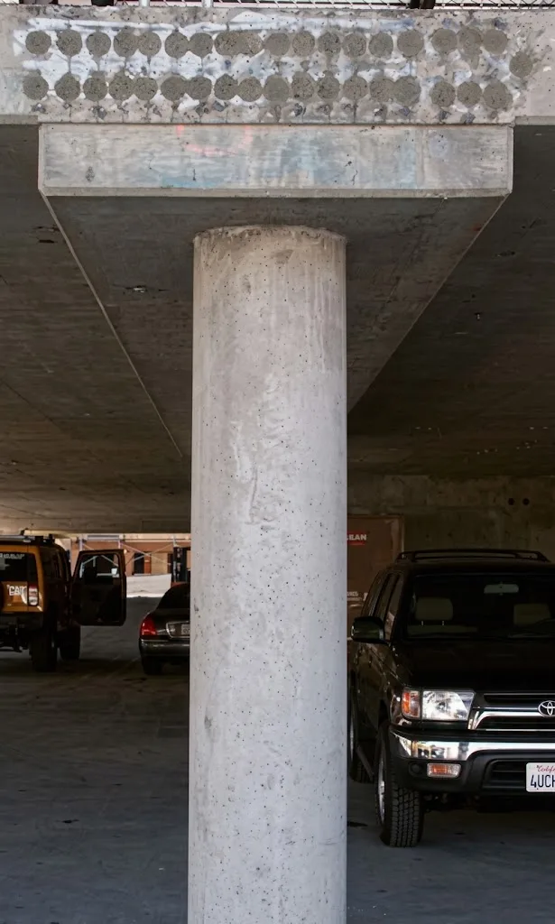Tell tail indication of a post tensioned concrete slab is the grouting of the live end stressing pockets on the slab edge or slab surface