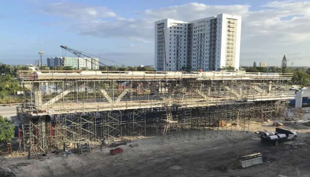 Image showing the main truss span of the FIU bridge and its formwork on the side of the roadway near the construction site