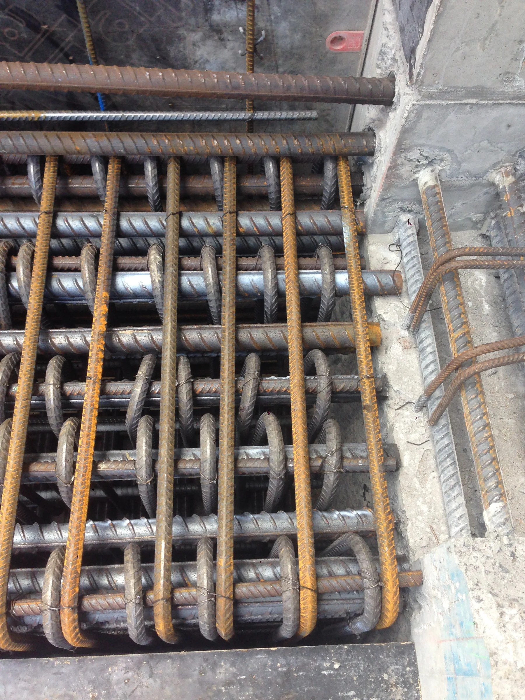 An example construction joint in a slab with significant reinforcing bar protruding through the joint.
