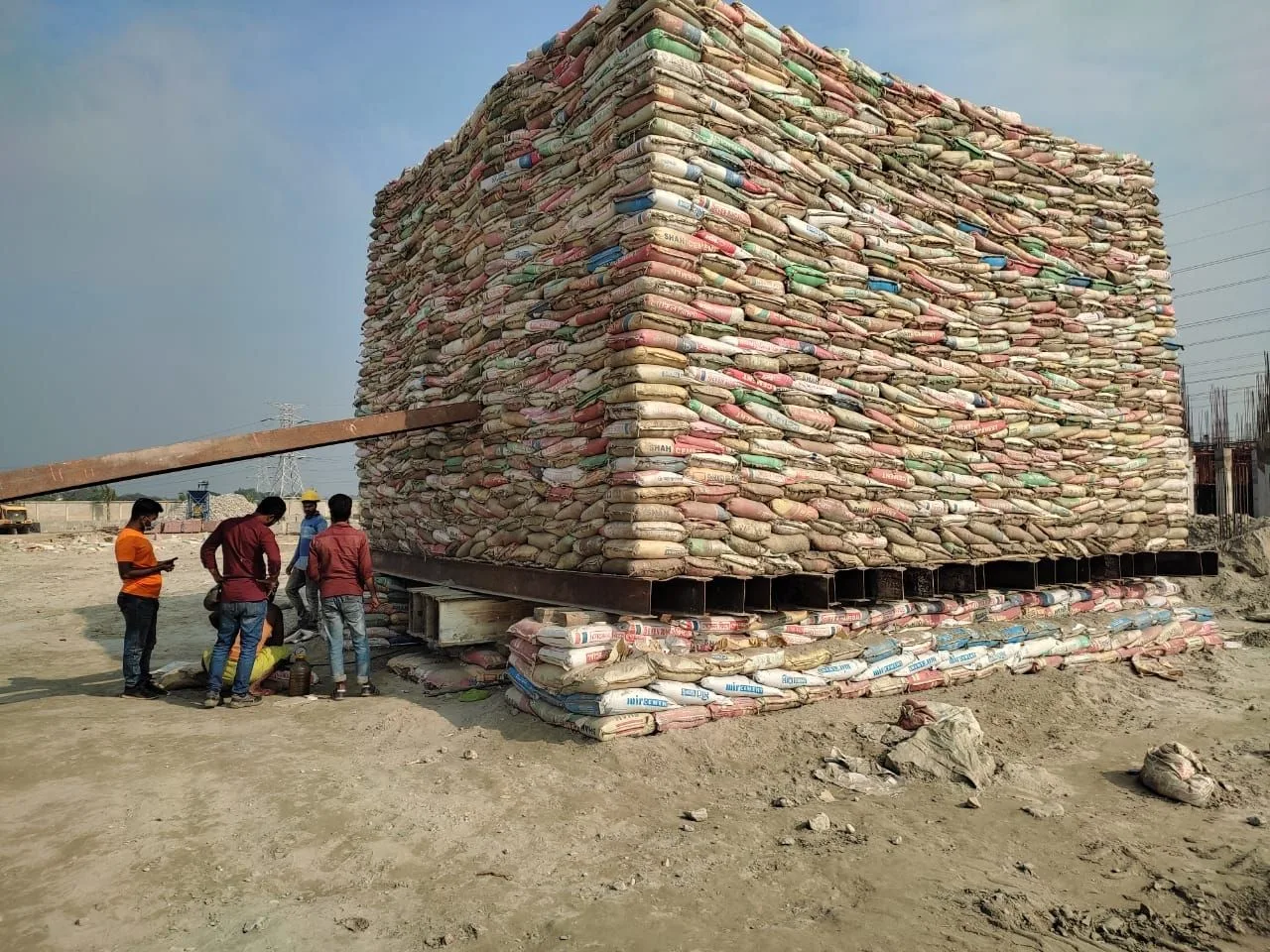 Image of a standard static load pile testing using sand bags as dead load
