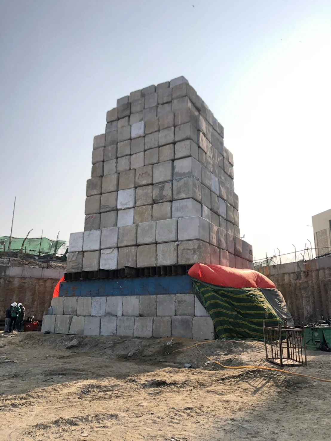 Image of a standard static load pile testing using concrete blocks as dead load