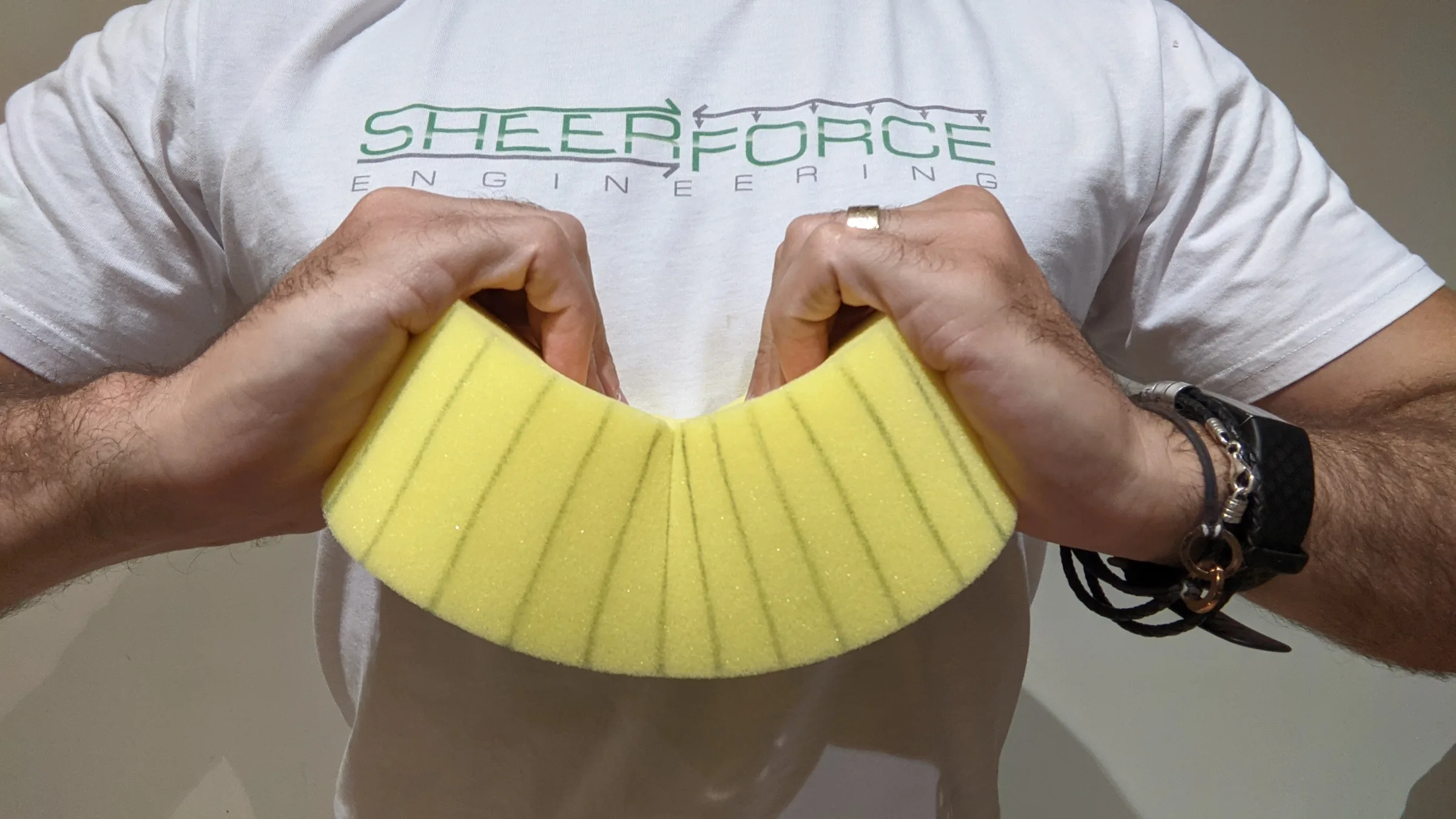 A great way to visualise bending behaviour of a beam is to take a sponge and apply bending moment at each end as demonstrated in this image, this results in the expected tension/compression coupling which is easier visualised compared to a steel beam in bending.