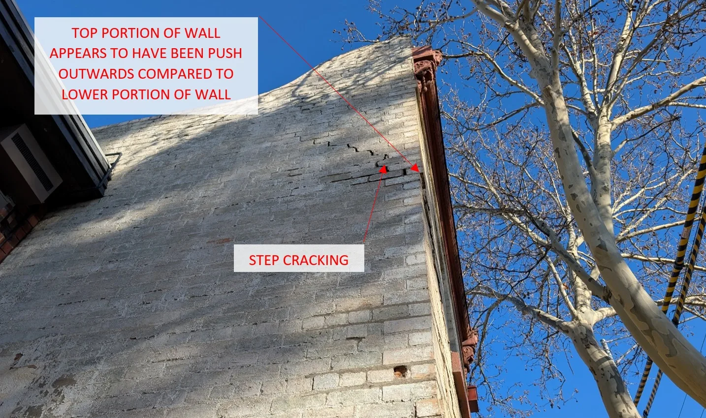 The crack pattern suggested lateral movement of the wall rather than predominantly vertical settlement.