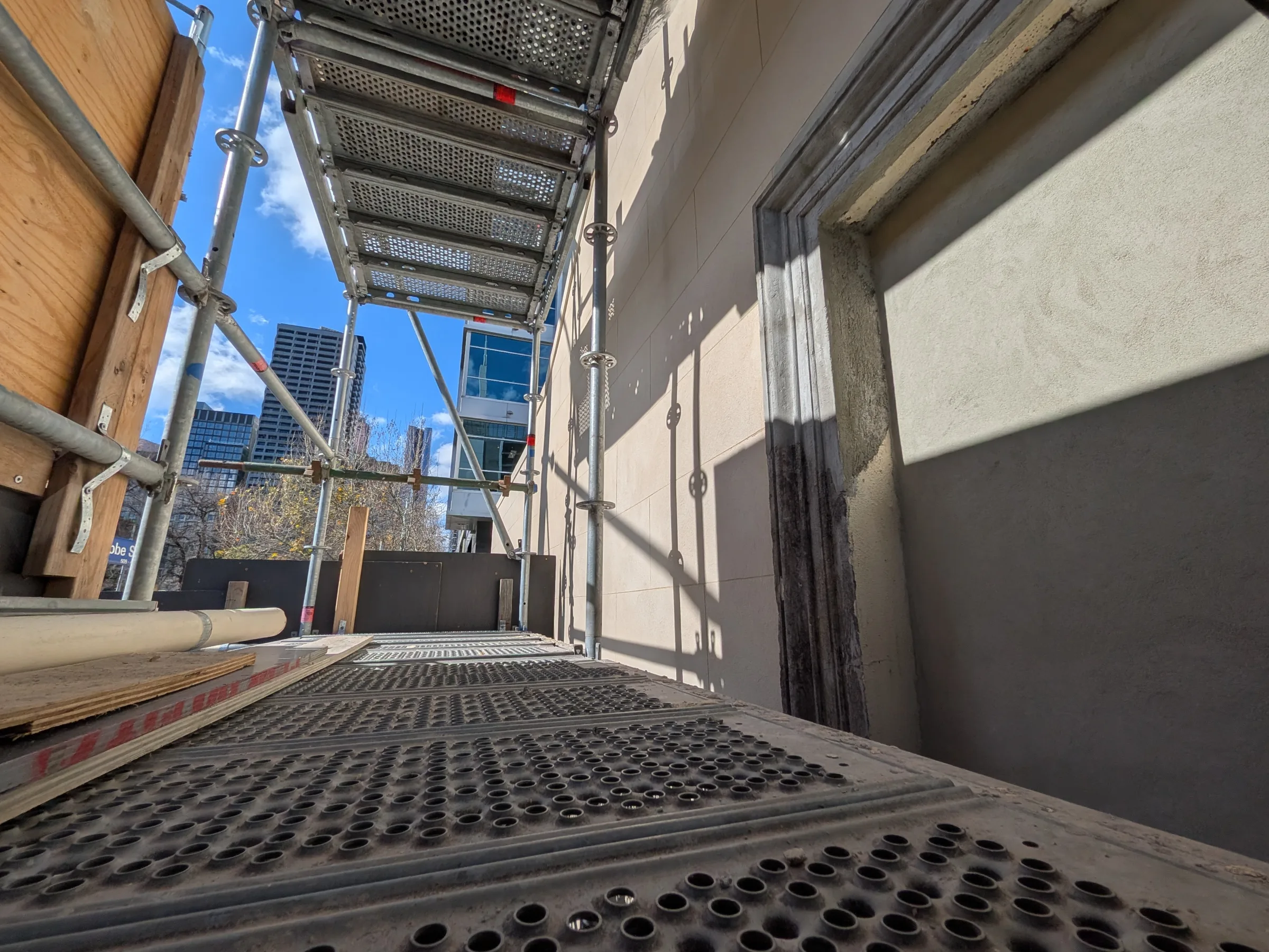 The newly rendered masonry facade viewed from the temporary access scaffold