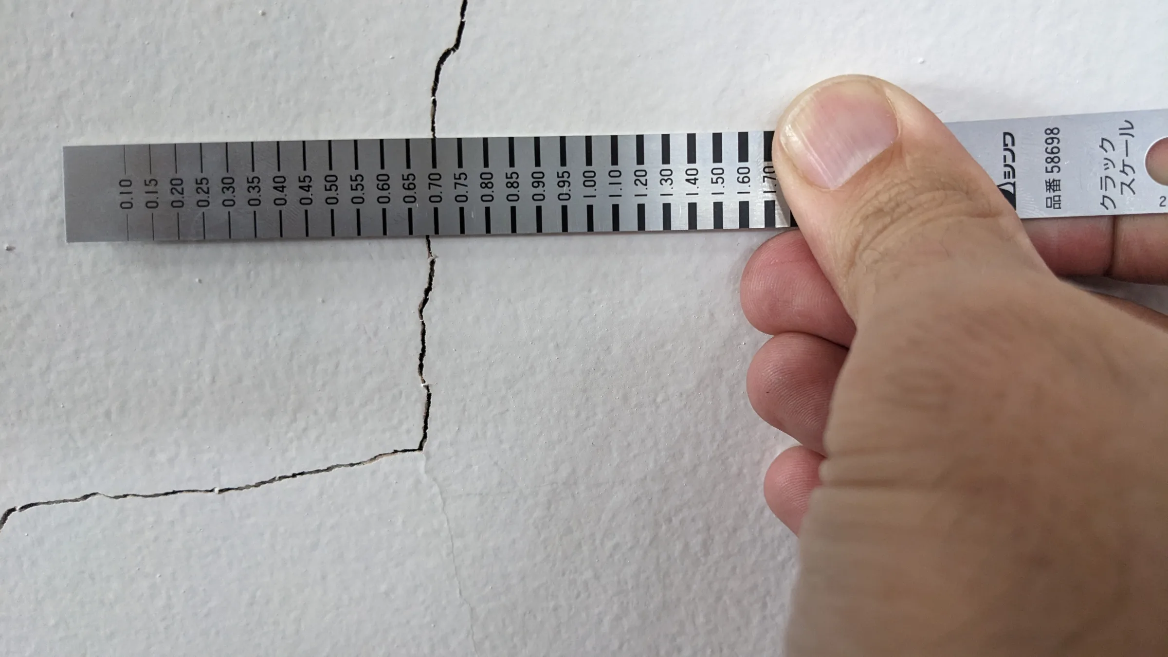 Detailed inspection of the crack pattern and masonry condition.